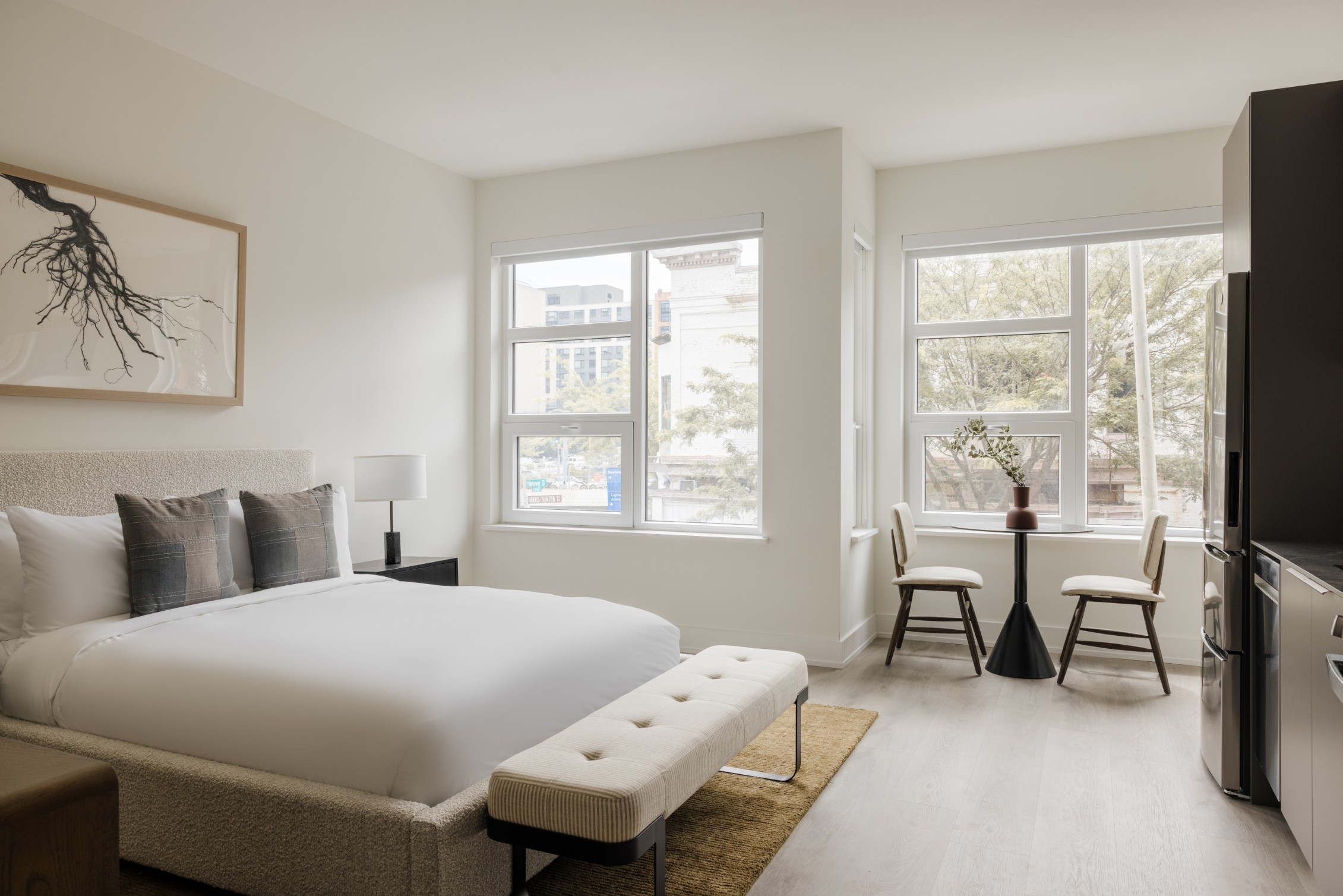 Spacious bedroom with seating by large windows at 1324 NoMa